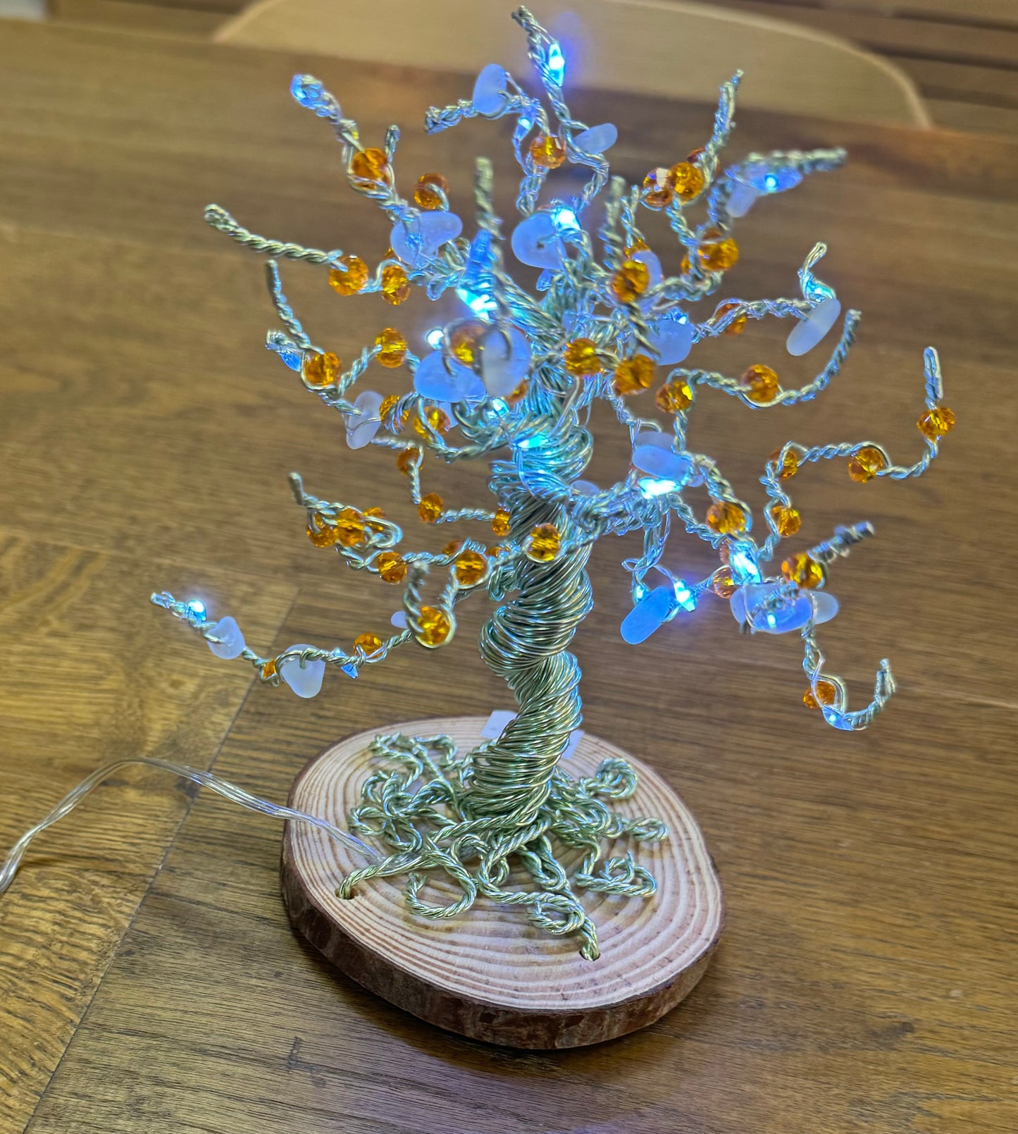 Wire and Sea glass tree. Green wire, White Sea glass, orange crystal beads and white LED LIGHTS