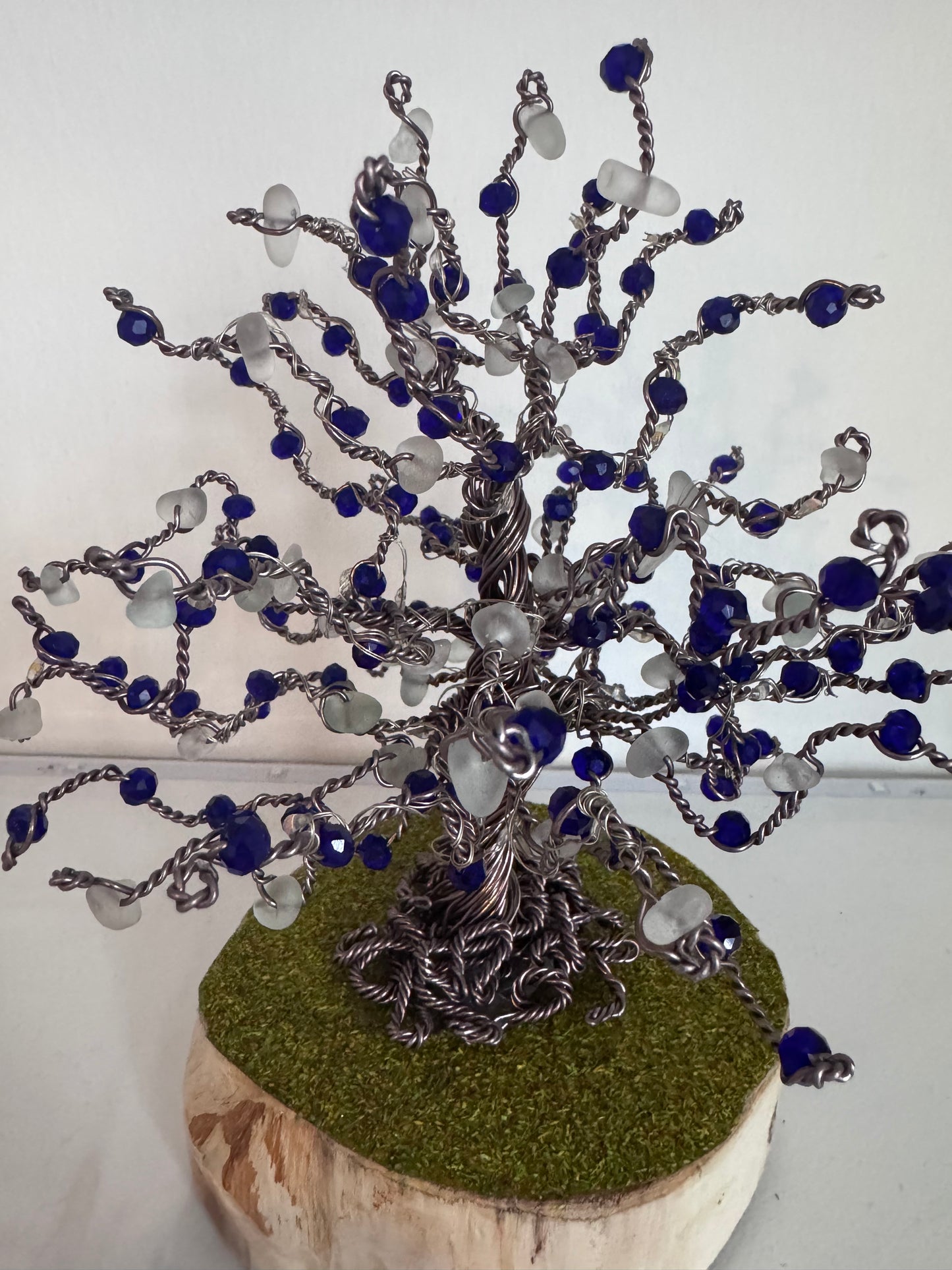 Wire and sea glass tree. Bronze wire, White Sea glass and blue crystal beads with multi coloured LED lights