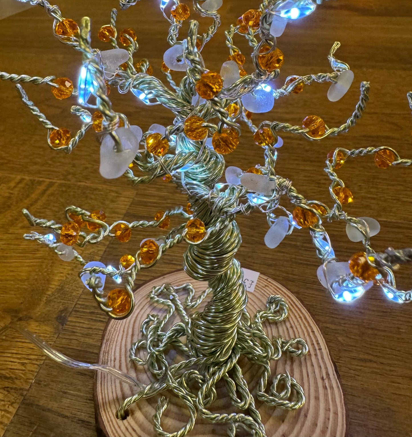 Wire and Sea glass tree. Green wire, White Sea glass, orange crystal beads and white LED LIGHTS