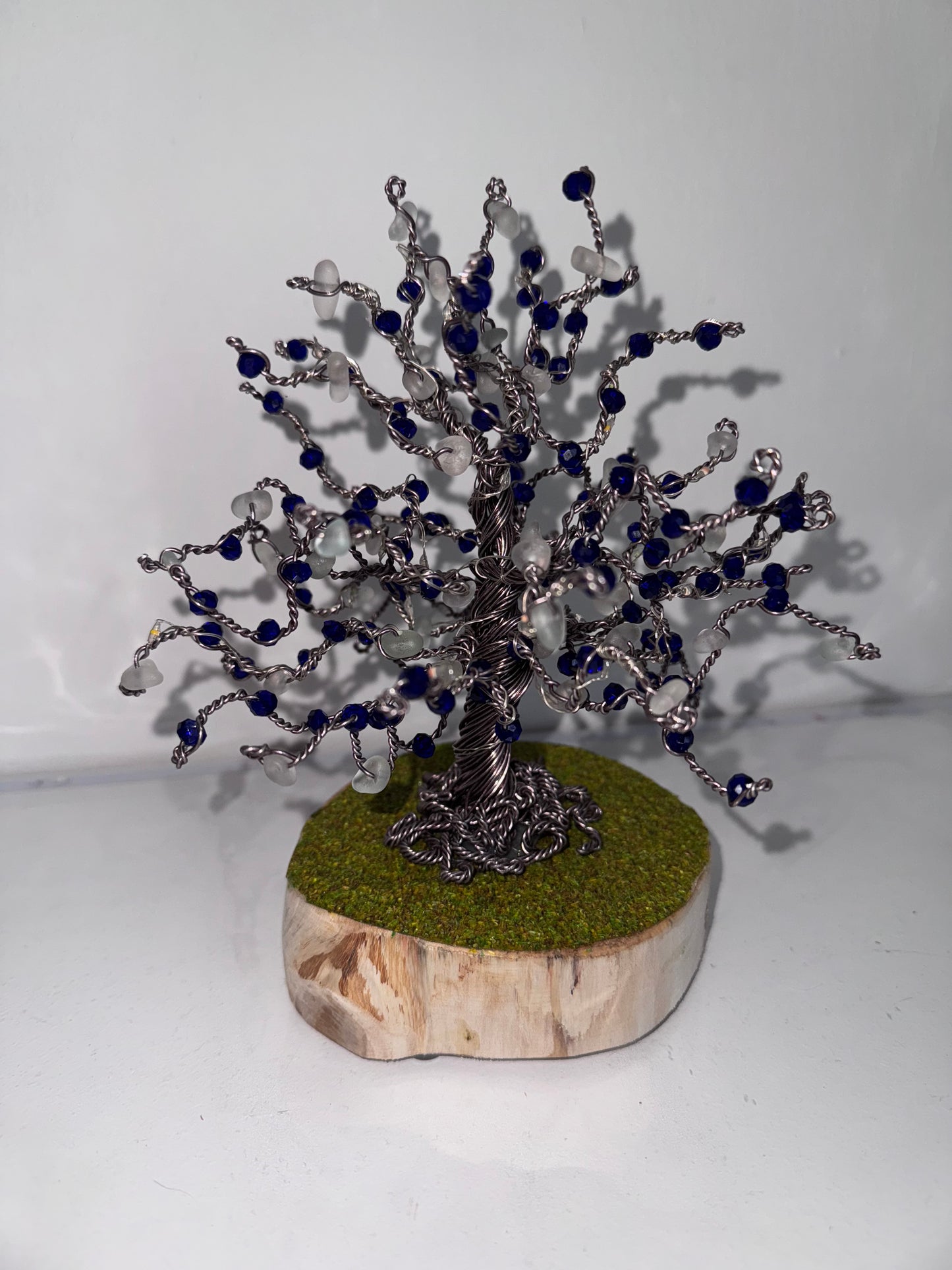 Wire and sea glass tree. Bronze wire, White Sea glass and blue crystal beads with multi coloured LED lights