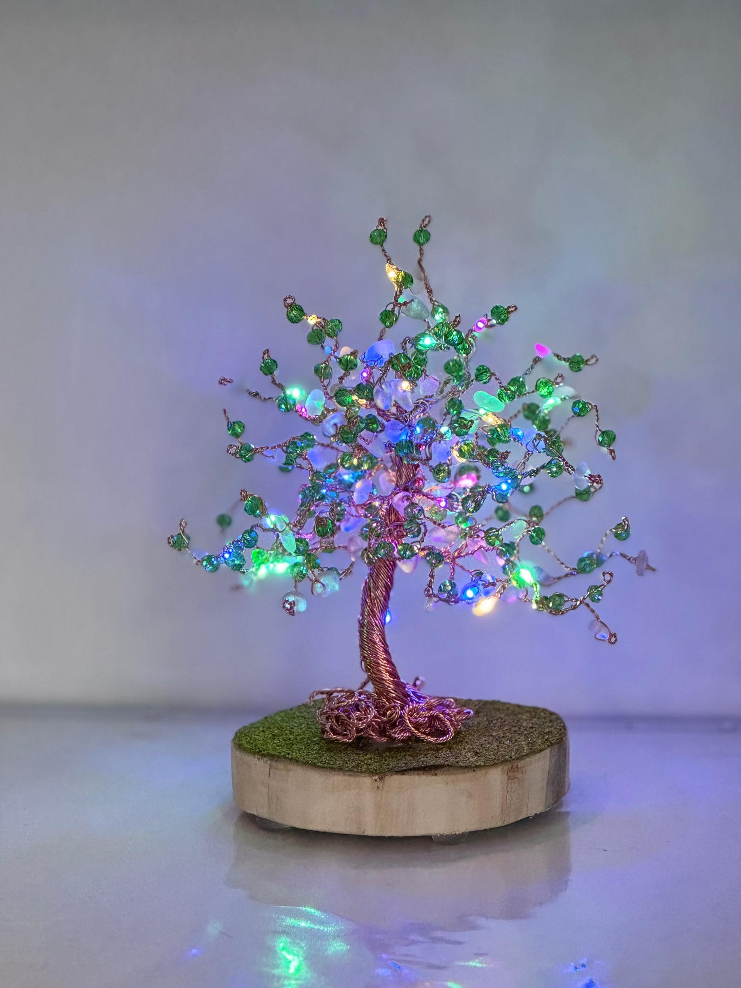 Wire and sea glass tree. Bronze wire, white glass and green crystal beads with multi coloured LED lights