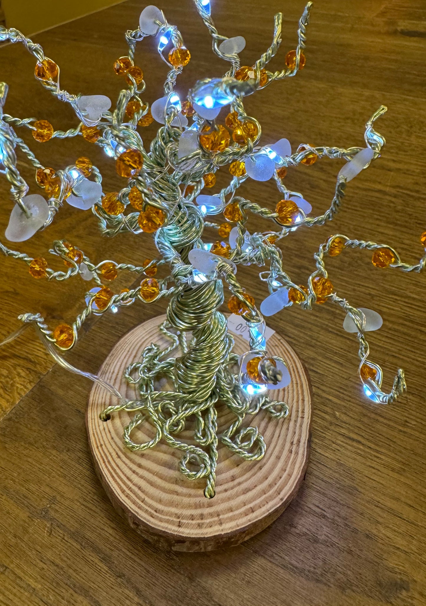 Wire and Sea glass tree. Green wire, White Sea glass, orange crystal beads and white LED LIGHTS
