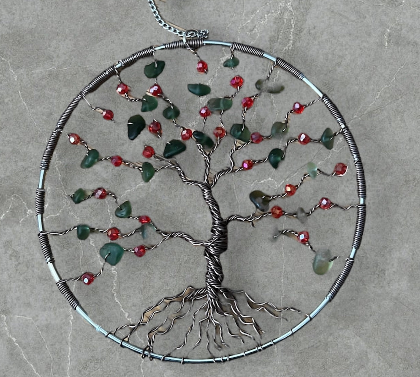 Sea glass tree of life Sun catcher, bronze wire, red crystal beads and green sea glass.