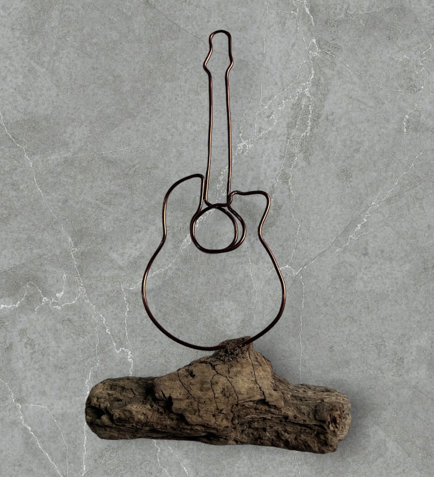 Guitar wire silhouette on Driftwood