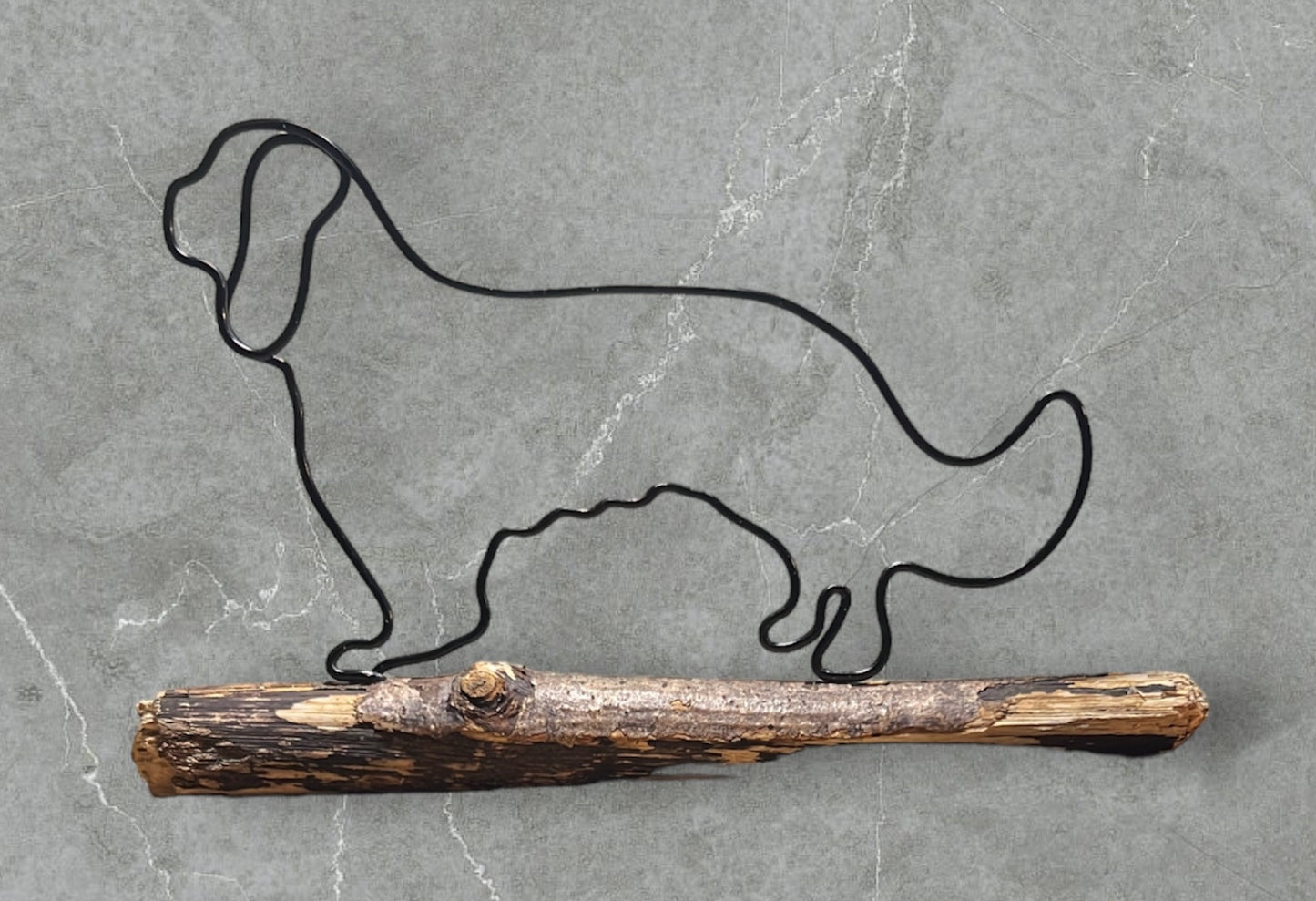 Cavalier King Charles spaniel wire silhouette on driftwood