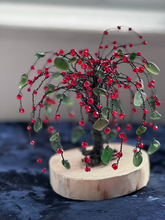 Sea glass willow tree, black wire with green sea glass and red crystal beads