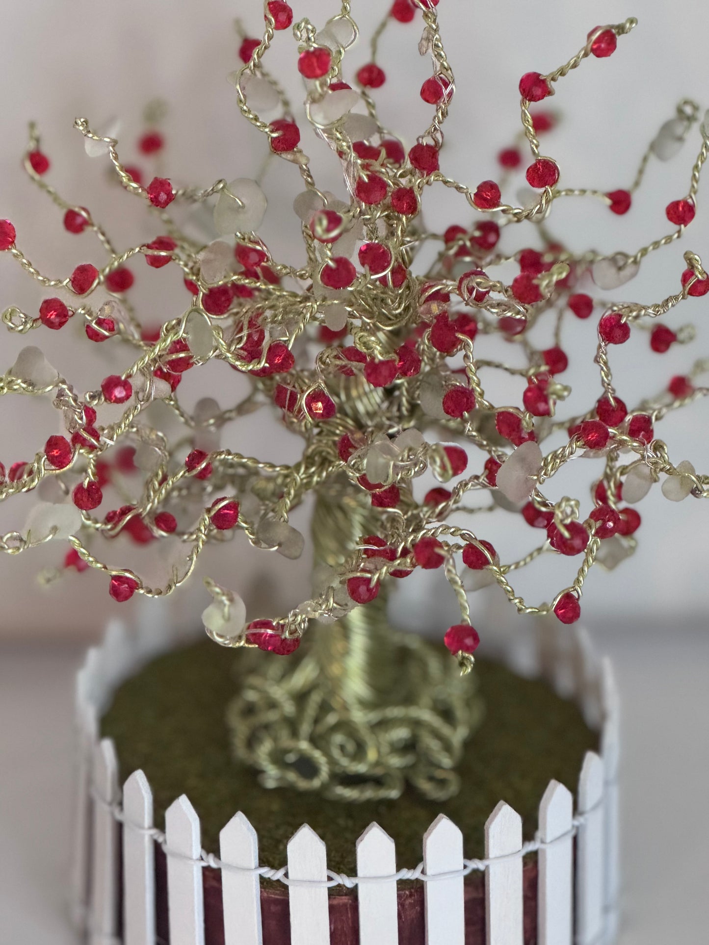 Sea glass tree with mini picket fence. Green wire with White Sea glass and red crystal beads and LED Lights