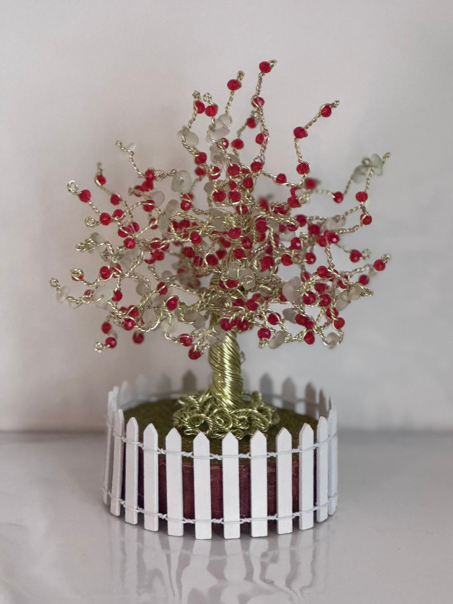 Sea glass tree with mini picket fence. Green wire with White Sea glass and red crystal beads and LED Lights