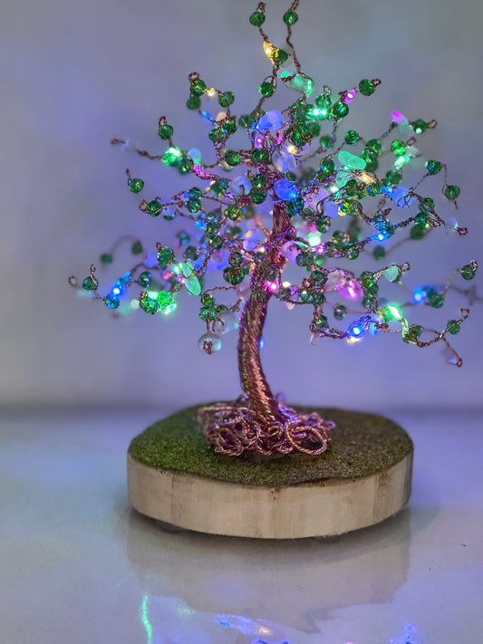 Wire and sea glass tree. Bronze wire, white glass and green crystal beads with multi coloured LED lights