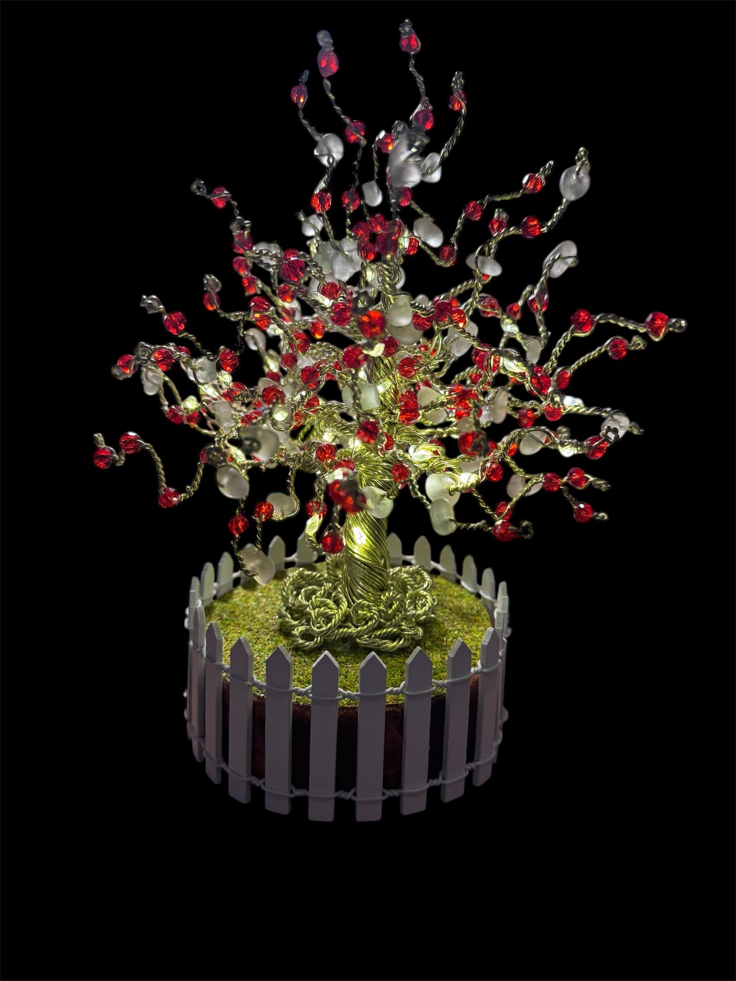 Sea glass tree with mini picket fence. Green wire with White Sea glass and red crystal beads and LED Lights