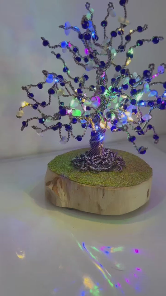 Wire and sea glass tree. Bronze wire, White Sea glass and blue crystal beads with multi coloured LED lights